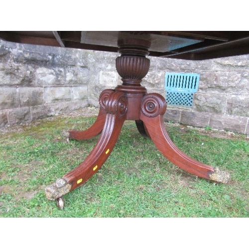 16 - A 19th century mahogany breakfast table, raised on a column with four reeded legs terminating in cas... 