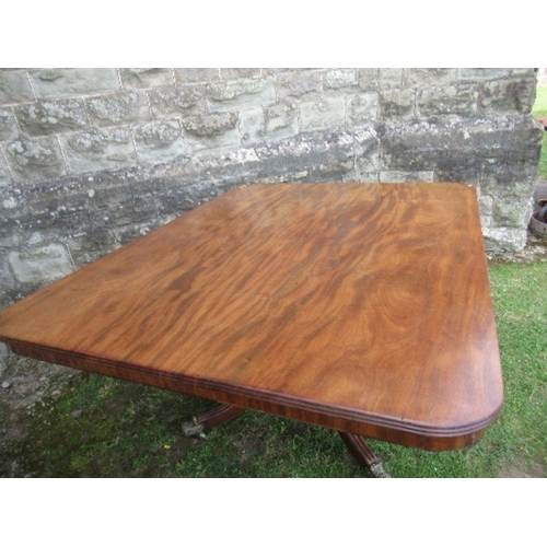 16 - A 19th century mahogany breakfast table, raised on a column with four reeded legs terminating in cas... 