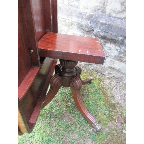 16 - A 19th century mahogany breakfast table, raised on a column with four reeded legs terminating in cas... 