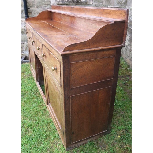 22 - An antique oak Welsh sideboard, with three drawers to the frieze, above cupboard doors to each side,... 