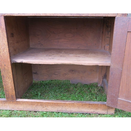 22 - An antique oak Welsh sideboard, with three drawers to the frieze, above cupboard doors to each side,... 