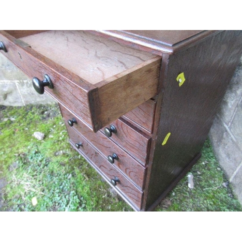 28 - A 19th century late Georgian oak miniature chest of drawers, having five graduated drawers with ebon... 