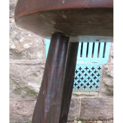 29 - An Antique cricket style table, with circular top and raised on three legs, diameter 16ins, height 2... 