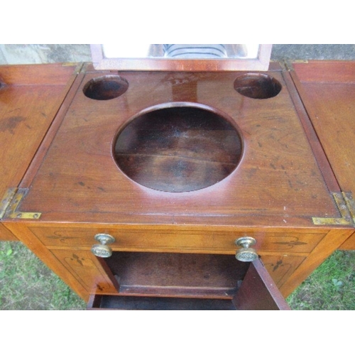 32 - A 19th century mahogany folding pot cupboard / dressing table, the top opening to reveal apertures a... 