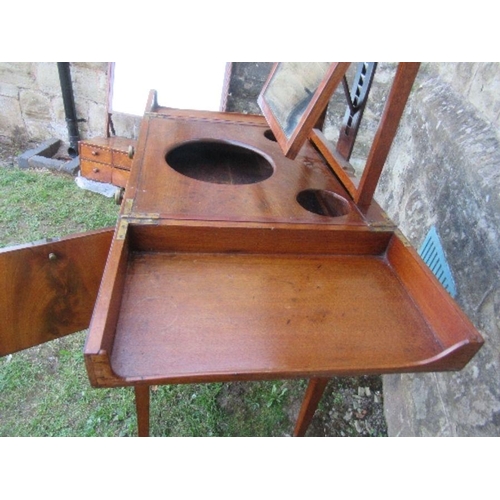 32 - A 19th century mahogany folding pot cupboard / dressing table, the top opening to reveal apertures a... 