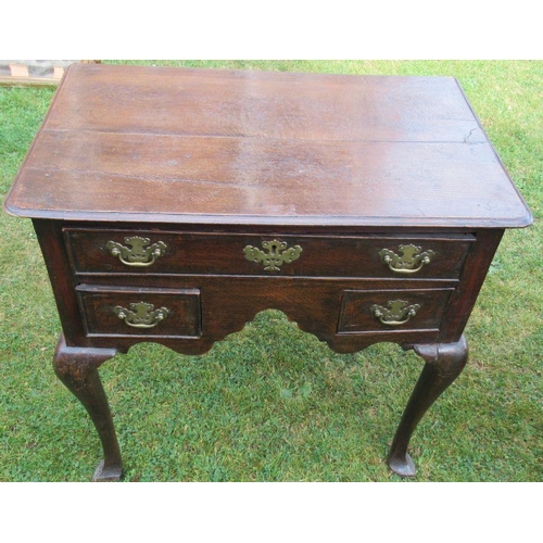 38 - An Antique oak lowboy, fitted one long drawer and two short drawers, raised on cabriole legs and pad... 