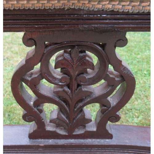 39 - A late 19th century mahogany and upholstered chaise longue, with pierced carved uprights, raised on ... 