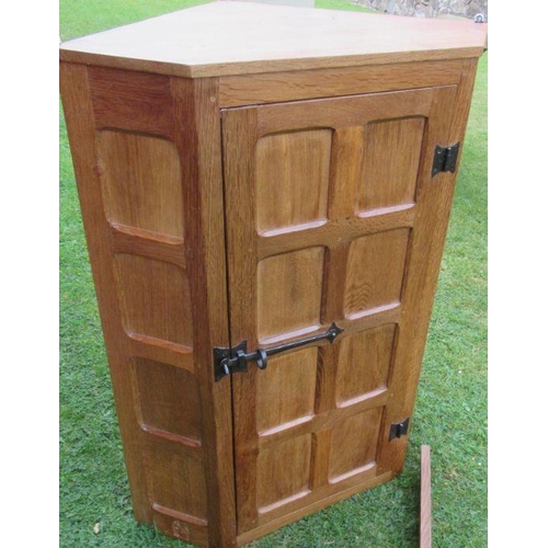 42 - Wilf Squirrel Man Hutchinson, an oak corner cabinet, with panelled door, width 27.5ins, height 36.5i... 