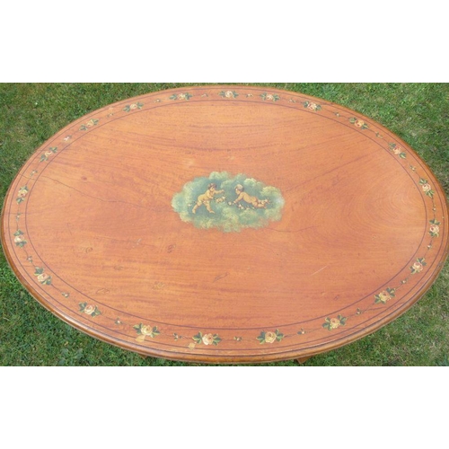 44 - An Edwardian satinwood oval occasional table, decorated to the top and frieze with putti and flowers... 