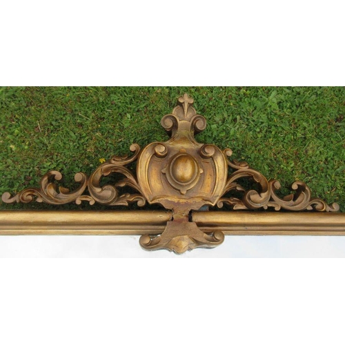 59 - A gilt framed over mantel mirror, of rectangular form, with scroll and leaf decoration, overall dime... 