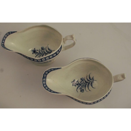 732 - A pair of First Period Worcester blue and white sauce boats, decorated with flowers to an embossed b... 