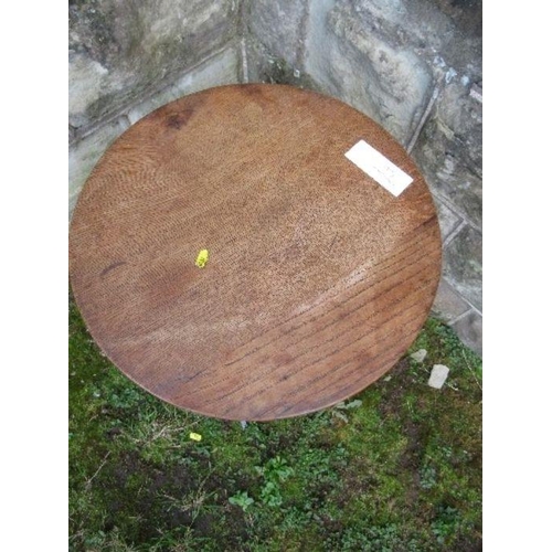 9 - A Bromsgrove Guild occasional table, the circular oak top over wrought iron base, diameter 18ins x h... 