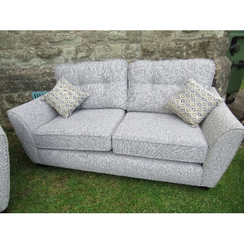 11 - A two seat sofa, together with a single armchair, in grey upholstery, with fire labels