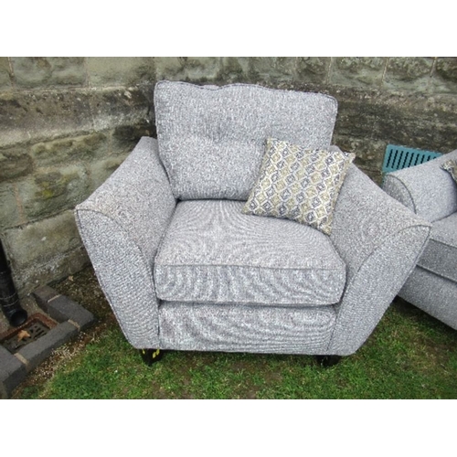 11 - A two seat sofa, together with a single armchair, in grey upholstery, with fire labels