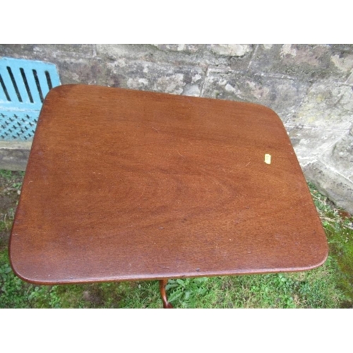 18 - A mahogany occasional table, having rectangular top raised on a turned column, terminating in out sw... 