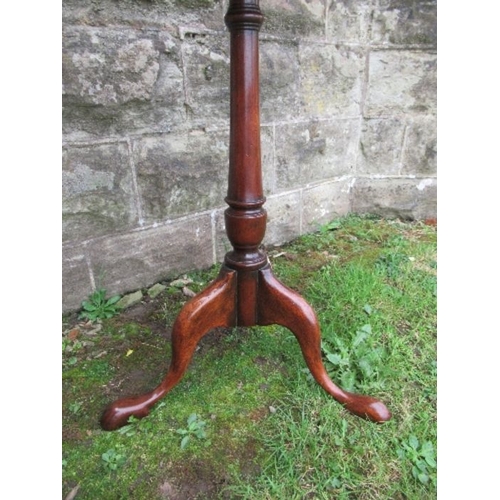 18 - A mahogany occasional table, having rectangular top raised on a turned column, terminating in out sw... 