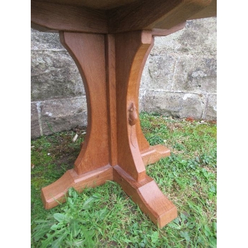 23 - A Robert Mouseman Thompson oak octagonal occasional  table, with adzed finish, height 19ins, diamete... 