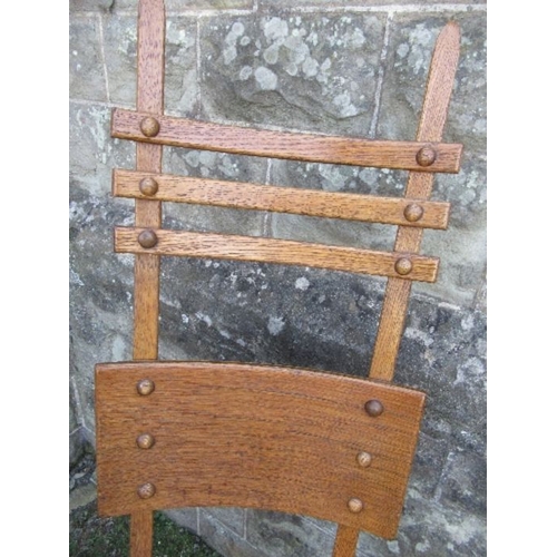 19 - An unusual Arts and Crafts style high ladder back oak chair, max height 49ins, seat width 19ins