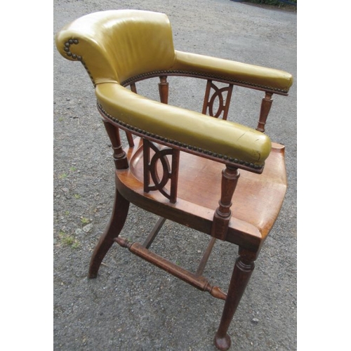 33 - A mahogany desk chair, the curved back with upholstered upper section, raised on turned spindles and... 