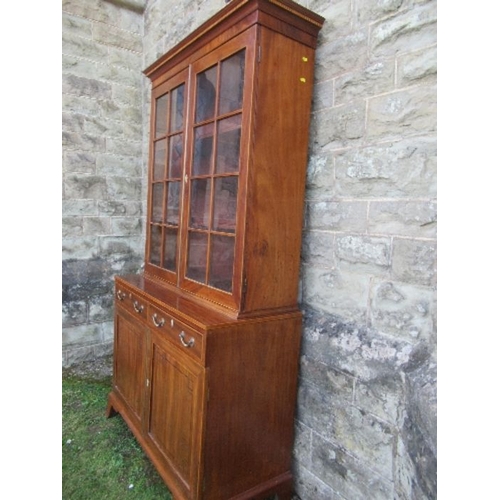 14 - A 19th century design mahogany glazed cabinet, the upper section having glazed doors opening to reve... 