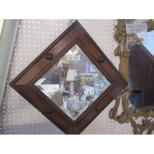 112 - An oak framed wall mirror, with carved and applied decoration, with bevelled glass plate, overall he... 