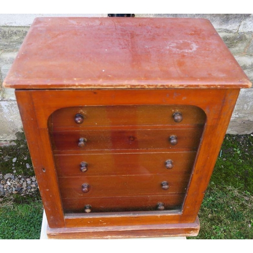 13 - A table top set of drawers, having a glazed door, with six drawers, 15ins x 10.25ins, height 18ins