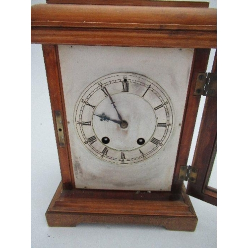 138 - A modern cased striking mantle clock, with square silvered dial, height 11ins