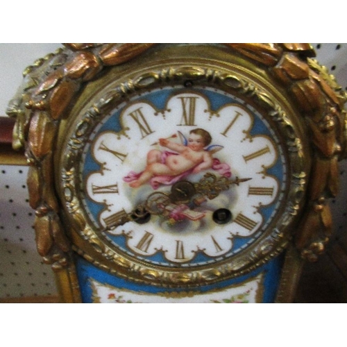 144 - A gilt metal and porcelain mantel clock, the porcelain panels decorated with cherubs and flowers, he... 