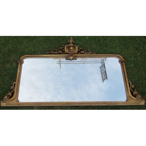 15 - A gilt framed over mantel mirror, of rectangular form, with scroll and leaf decoration, overall dime... 