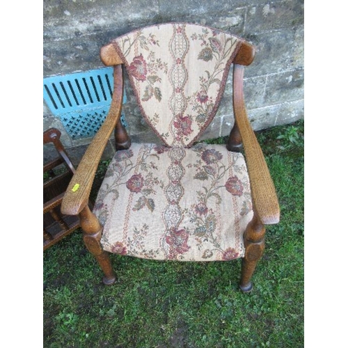 2 - An oak open arm chair, together with a magazine rack