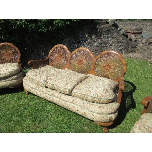 57 - A walnut framed bergere suite, comprising a three seat sofa width 67ins x height 31ins, and two sing... 