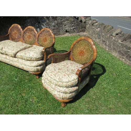 57 - A walnut framed bergere suite, comprising a three seat sofa width 67ins x height 31ins, and two sing... 