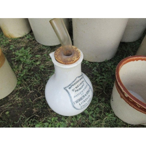 65 - A large collection of stoneware bottles, some with wicker mounts and a jug