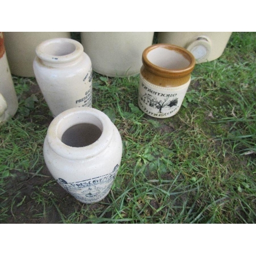 65 - A large collection of stoneware bottles, some with wicker mounts and a jug