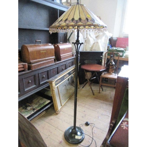 68 - A metal lamp standard, with Tiffany style leaded glass shade, height 62ins