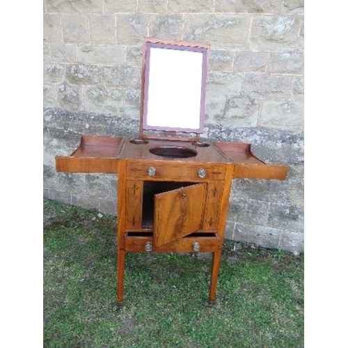 69 - A 19th century mahogany folding pot cupboard / dressing table, the top opening to reveal apertures a... 