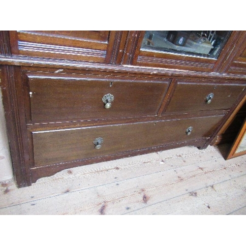 73 - An Edwardian mirror door wardrobe, with carved decoration and drawers to the base, width 49ins, heig... 