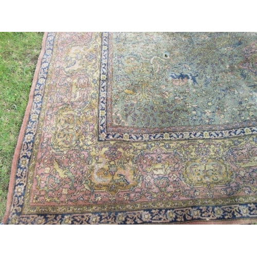 76 - A large Eastern design rug, decorated with animals hunting with foliage, 2 inch hole, 103ins x 145in... 