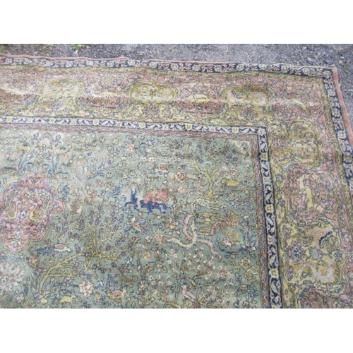 76 - A large Eastern design rug, decorated with animals hunting with foliage, 2 inch hole, 103ins x 145in... 