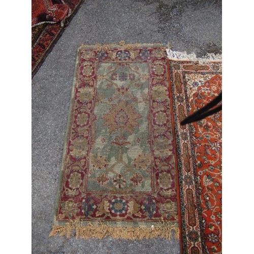 80 - An Eastern style runner, with orange ground field, 30ins x 100ins, together with another rug, 31ins ... 