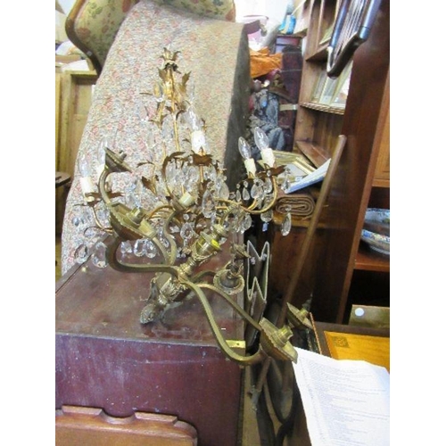 93 - A gilt metal chandelier light fitting, with leaf decoration and facetted clear droppers, height 27in... 