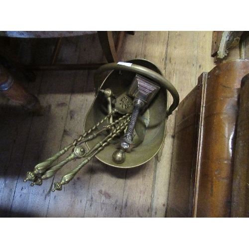 30 - A brass coal scuttle, together with fire tools, andirons and a candlestick