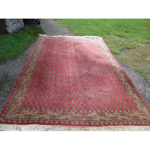 74 - An Eastern design rug, decorated with geometric pattern to a red ground, 78ins x 119ins