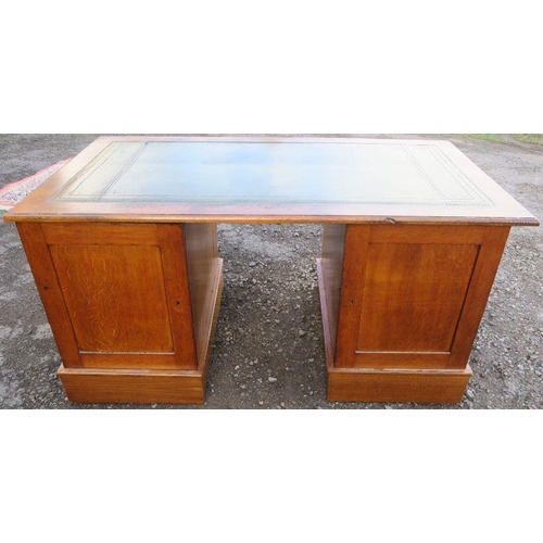 16 - An Edwardian oak pedestal desk, with leather inset writing surface, the pedestals fitted with drawer... 