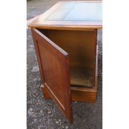 16 - An Edwardian oak pedestal desk, with leather inset writing surface, the pedestals fitted with drawer... 