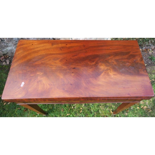 33 - A 19th century mahogany fold over card table, of rectangular form, raised on square tapering legs an... 