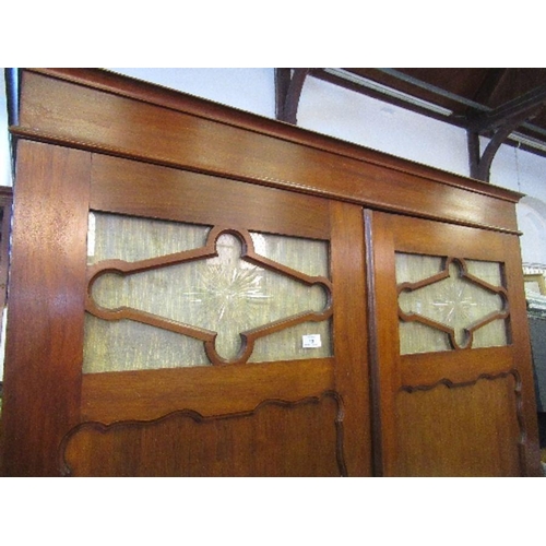 39 - A mahogany two door wardrobe, with glass panels to the doors, having with a shelf over hanging space... 