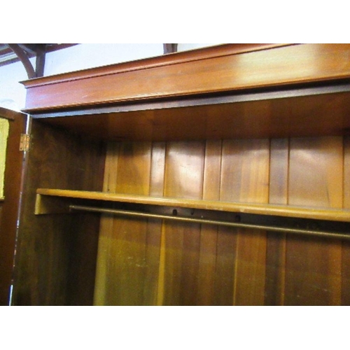 39 - A mahogany two door wardrobe, with glass panels to the doors, having with a shelf over hanging space... 