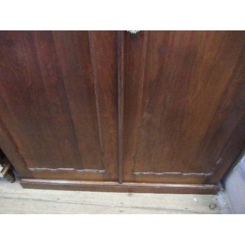 39 - A mahogany two door wardrobe, with glass panels to the doors, having with a shelf over hanging space... 