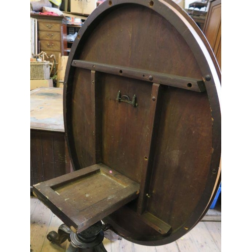 51 - A 19th century walnut oval quarter veneered loo table, raised on a central column, with four out swe... 